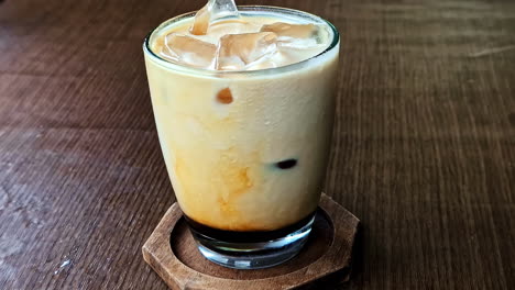 closeup footage cold coffee with ice on top served.
