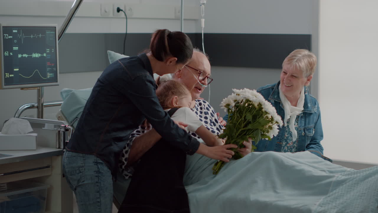 Family visiting elder patient with illness in hospital ward bed