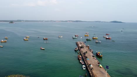 orbit shot of different fishing boats anchored in weligama harbor in calm blue ocean, sri lanka