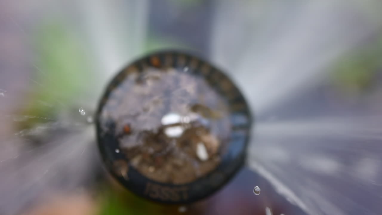 Chisinau, Moldova -August 20, 2025: Close up view of a sprinkler head spraying water with dirt in it