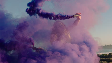 woman-dancing-with-purple-smoke-bomb-on-beach-celebrating-creative-expression-with-playful-dance-spin-in-slow-motion