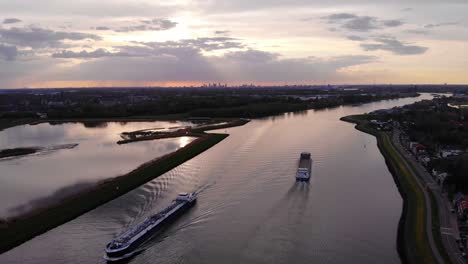 high aerial view of semper fi cargo vessel going past on river noord next to crezeepolder in alblasserdam during sunset