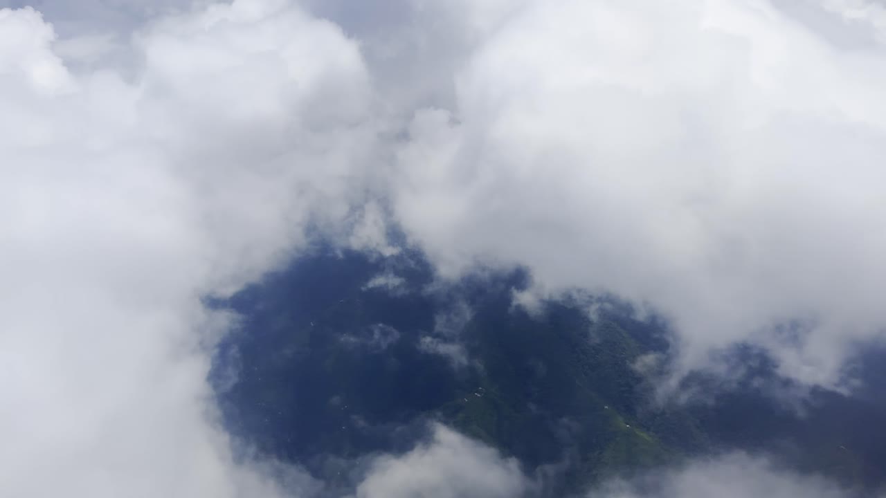 Footage of white clouds and sky in motion, captured from an airplane. Perfect for travel, aerial views, and nature projects, showcasing serene skies and dynamic movement above the landscape