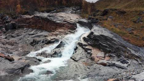 aerial view of the mountain river rushing through the rocky riverbed