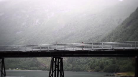 man walking on bridge in slow motion, with beautiful background view