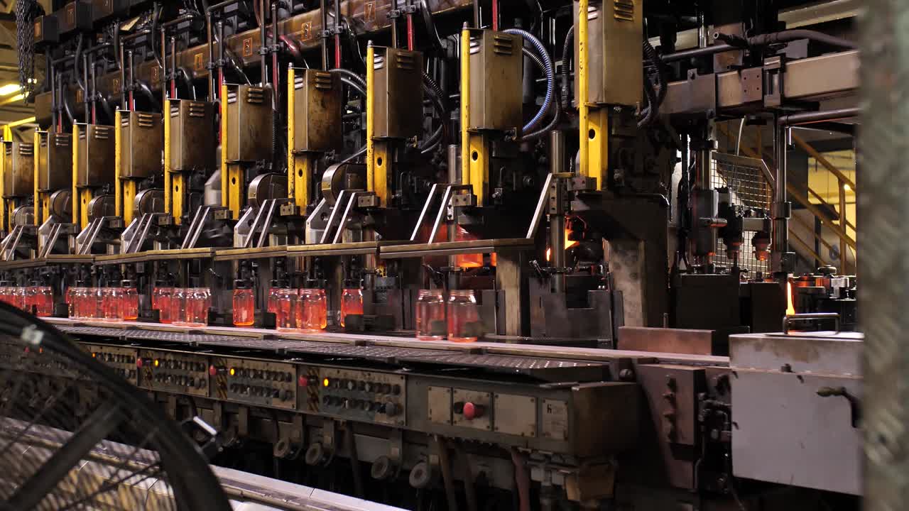 Glass jars on a conveyor belt. Slowmotion