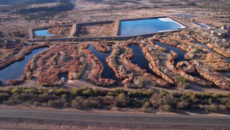 sedona wetlands preserve, waste sewage water treatment facility and traffic on state route, drone aerial view