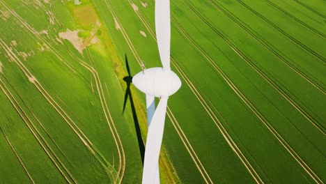 bright cinematic aerial of wind turbines in latvia green rural fields