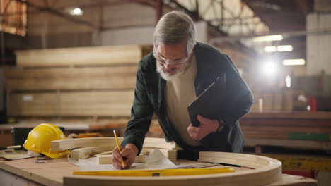 carpenter working on a blueprint in a workshop