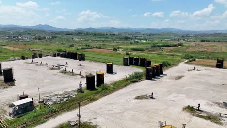 oil tanks on an industrial site with farming fields surrounding it