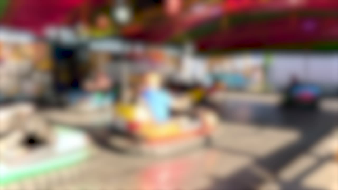 Colorful bumper cars in motion under bright lights at a lively carnival setting