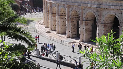 visitors strolling near the colosseum in rome, italy