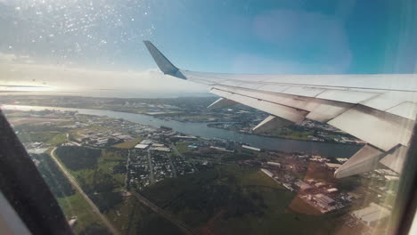 flying over the big brown brisbane river, queensland, australia. a view from airplane window