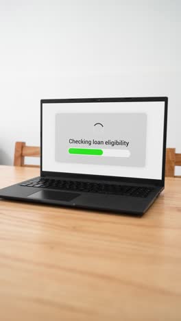 checking loan eligibility for financing with a laptop. concept of online banking system. vertical shot.