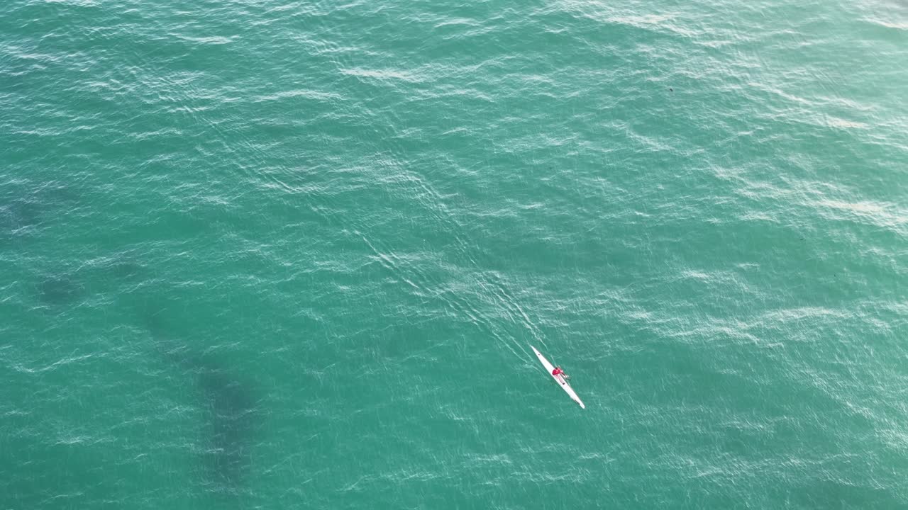 kayakista oceánico deslizándose sobre el agua al amanecer