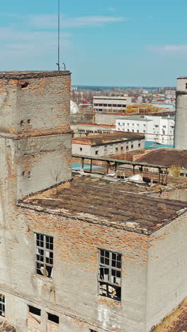 industrial buildings in abandoned factory. old ruined abandoned concrete factory exterior, aerial view vertical video