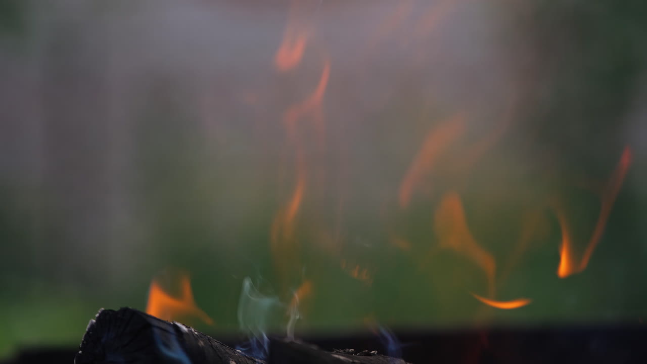 Background of burning hot coals. Close up view of bonfire burning outdoors