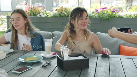 friends enjoying coffee and dessert at an outdoor cafe