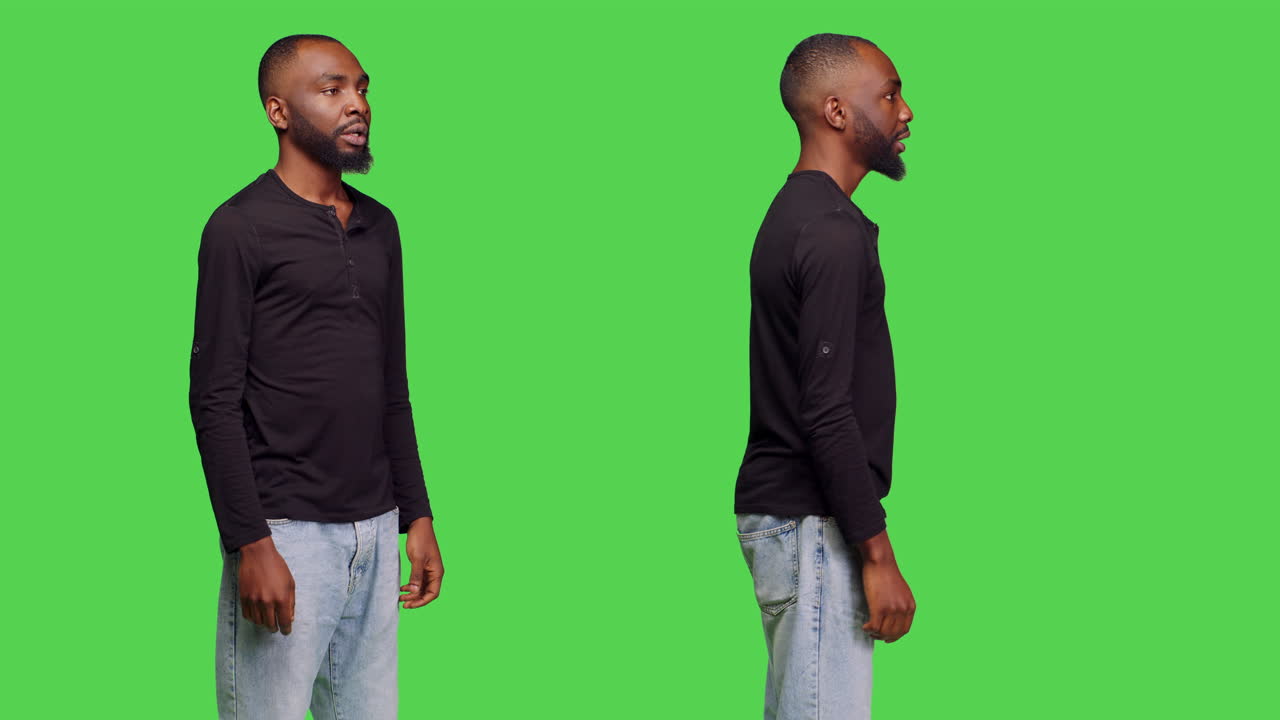 African American man in casual clothes posing in front of a green screen