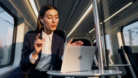 businesswoman working on laptop during train commute