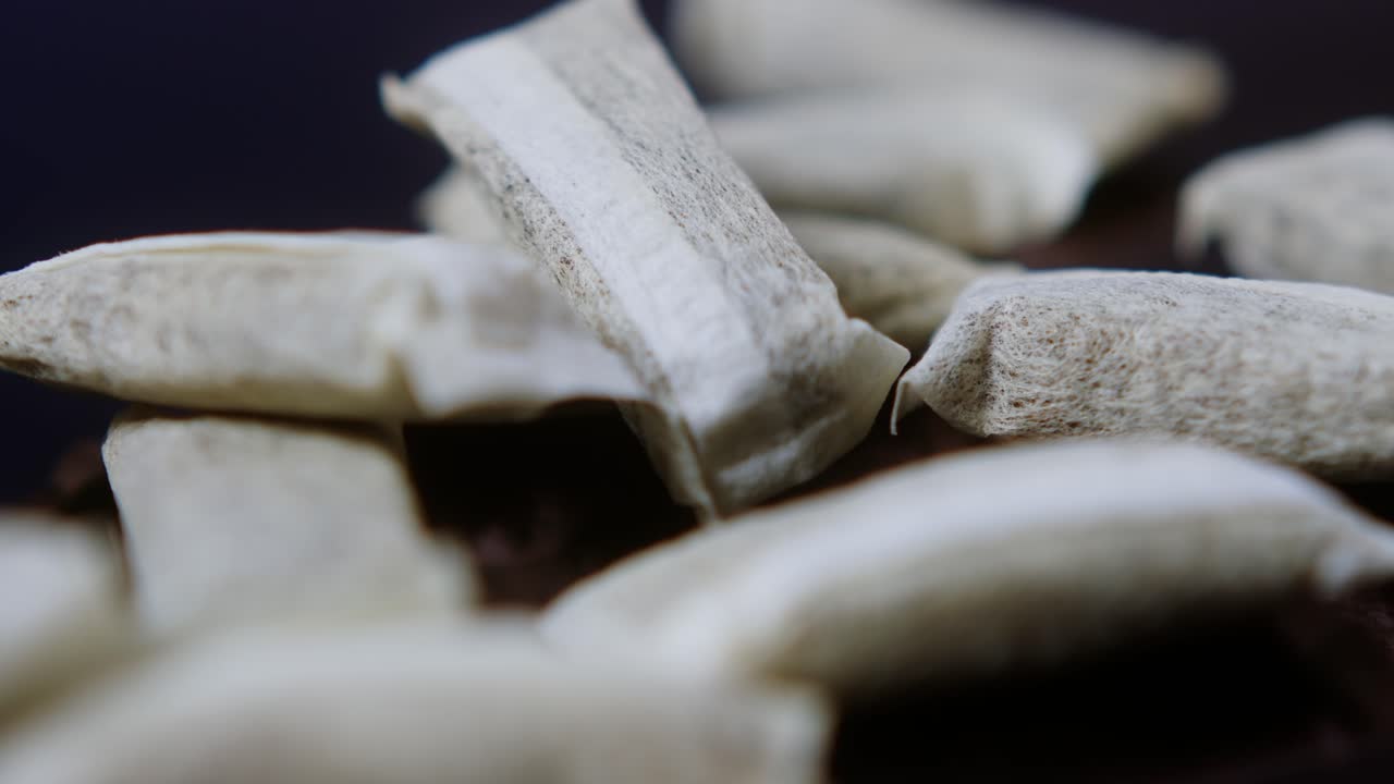 Snus nicotine tobacco close up, pack of tobacco for gum. unhealthy addiction. Man opening box with snus and taking one.