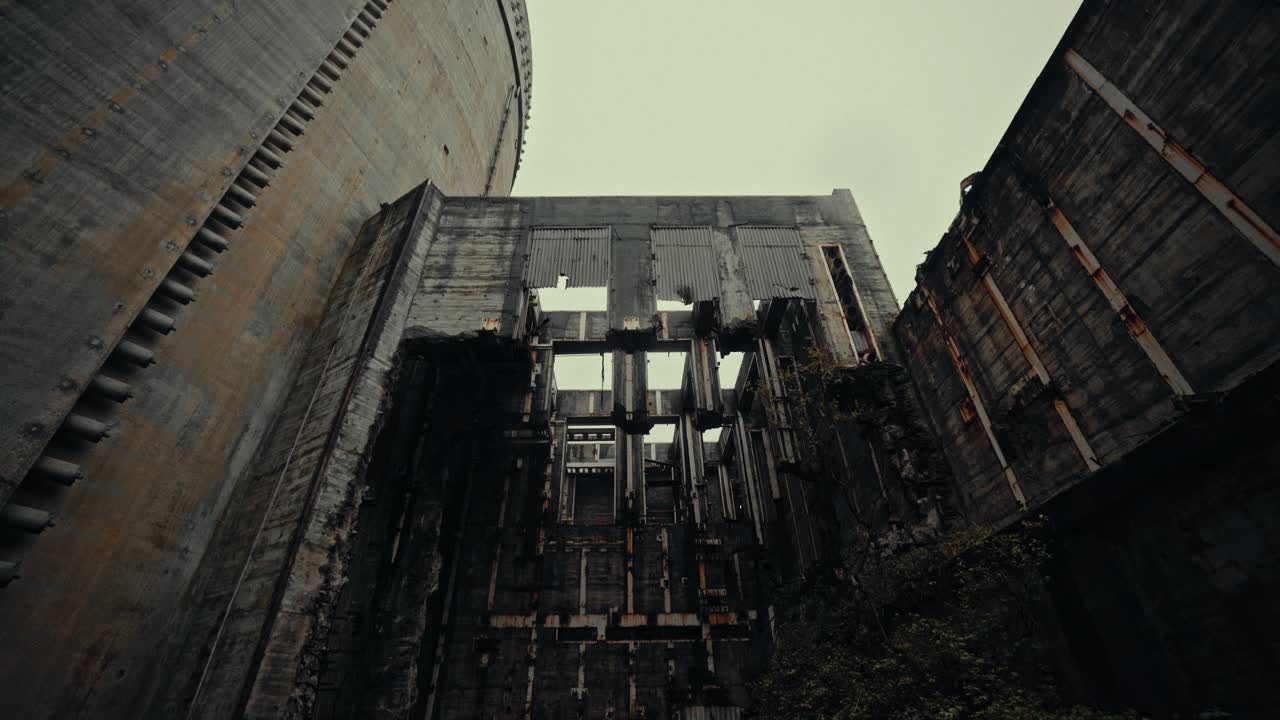 Low Angle View of Abandoned Industrial Concrete Building Under Overcast Sky