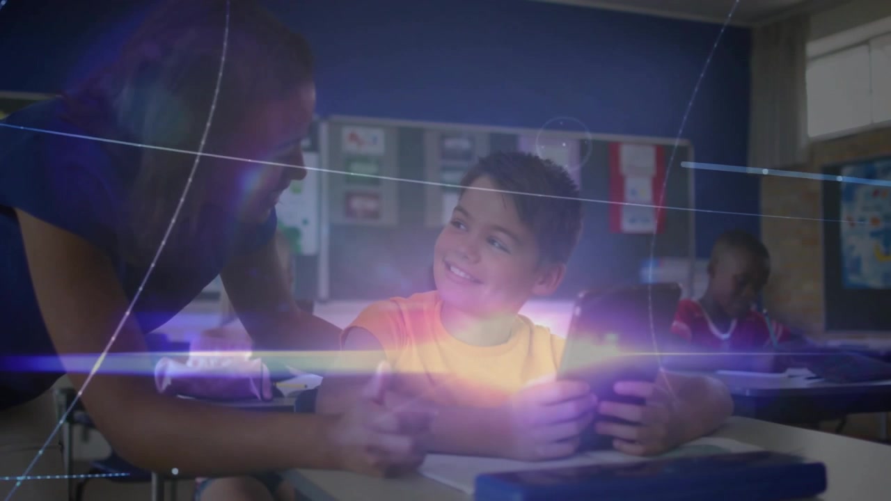 Teacher guiding student tapping tablet and activating animated graphics around them for education