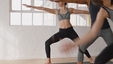 yoga class group of beautiful multiracial women practice warrior pose enjoying healthy lifestyle exercising in fitness studio meditation