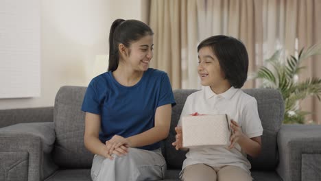 indian girl giving gift to her brother