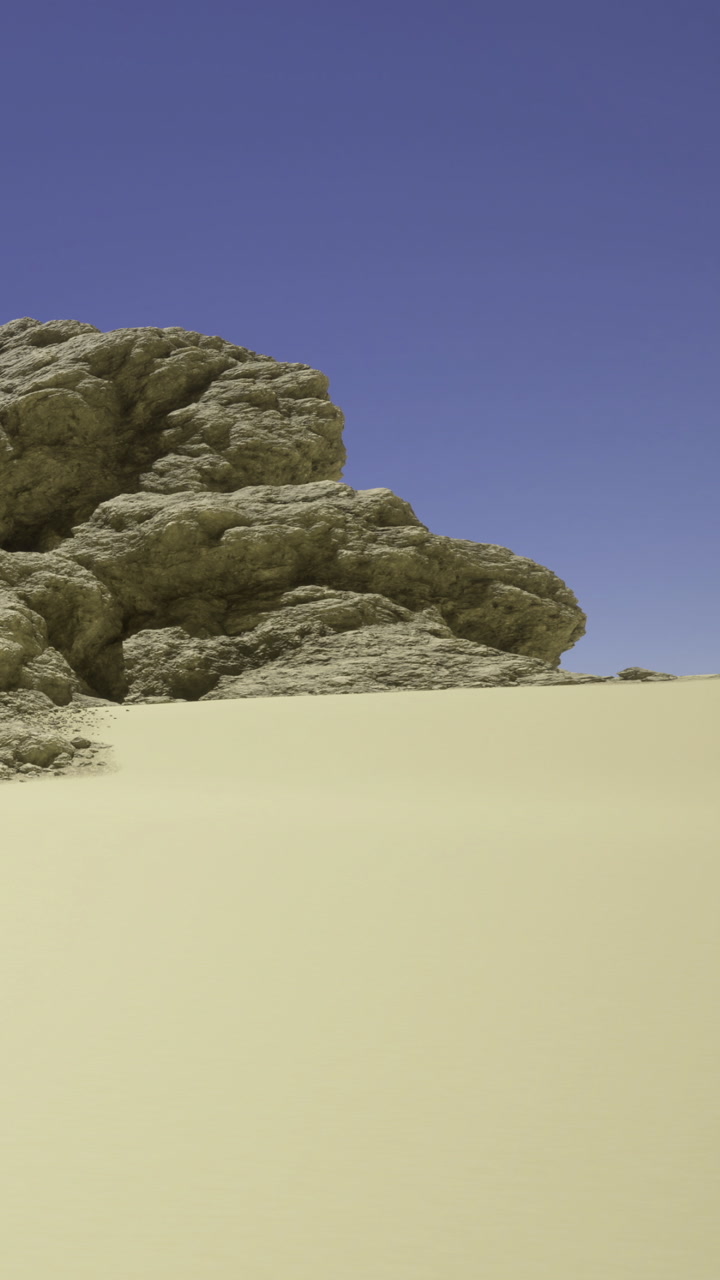 Majestic rock formations rise above golden sands under a bright blue sky