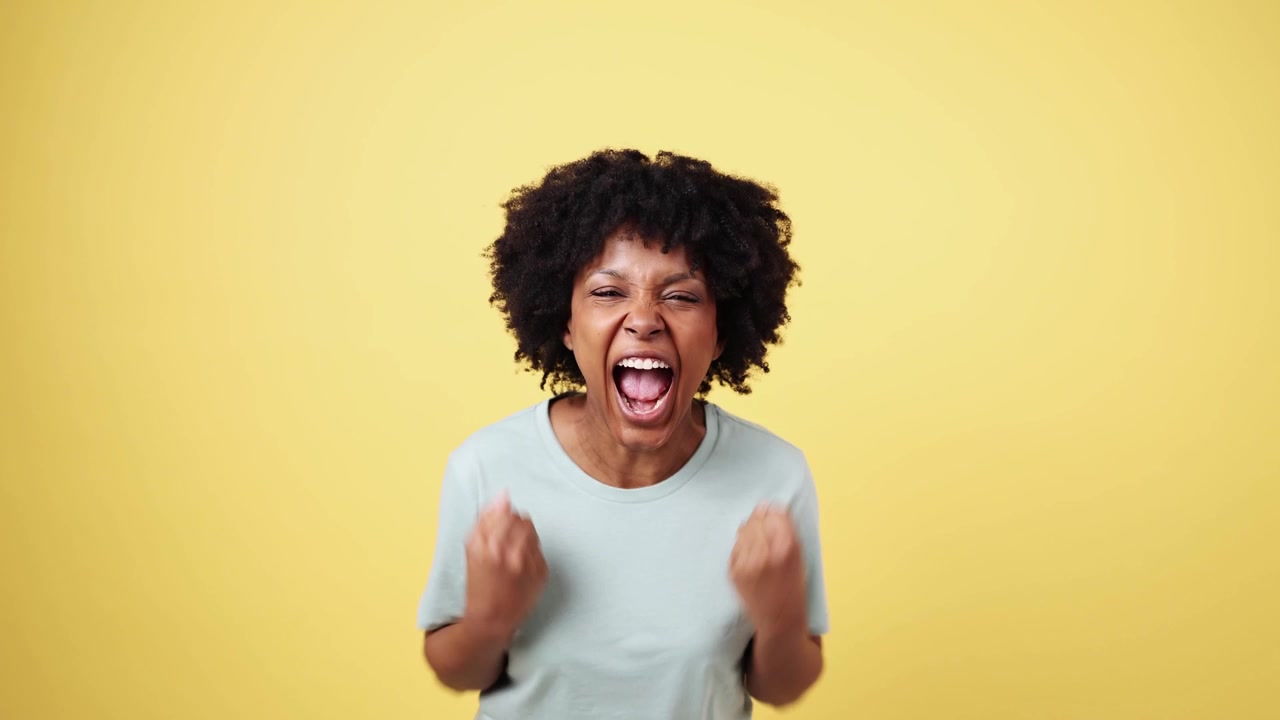 Excited African American Woman Cheering and Shouting in Joy