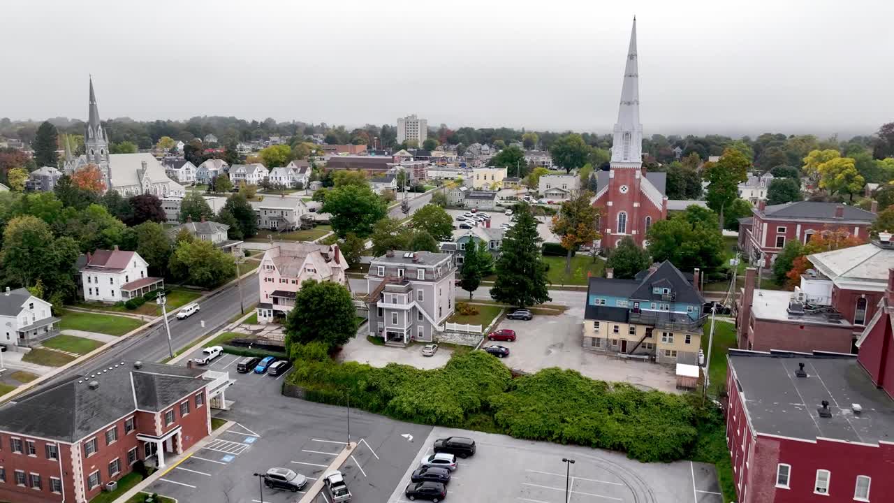 low fast aerial past downtown in Rutland Vermont