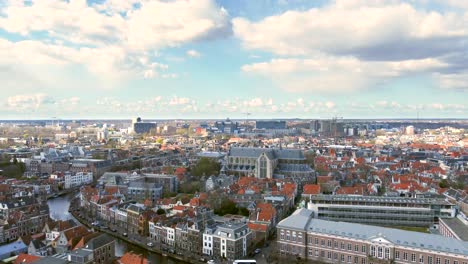 aerial shot flying up over the ancient city of leiden, revealing the faculty of law of leiden university, the pieterskerk and the rapenburg canal