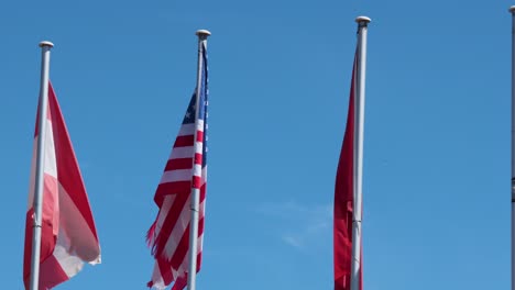 flags of austria and usa waving in wind