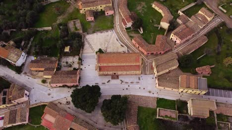 Tratalias-townscape-Romanic-church-top-aerial-view,-rising,-Sardinia-travel