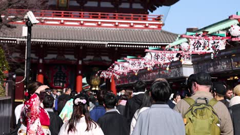 crowd in kimonos celebrates at temple gates