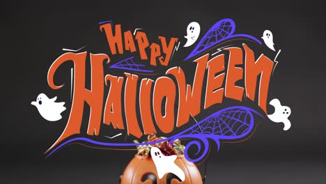 Animation-of-happy-halloween-text-with-ghosts-over-orange-pumpkin-bucket-with-sweets