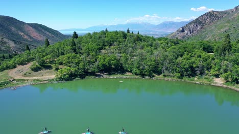 paddleboarding on mountain lake in utah with inflatable sup aerial drone footage