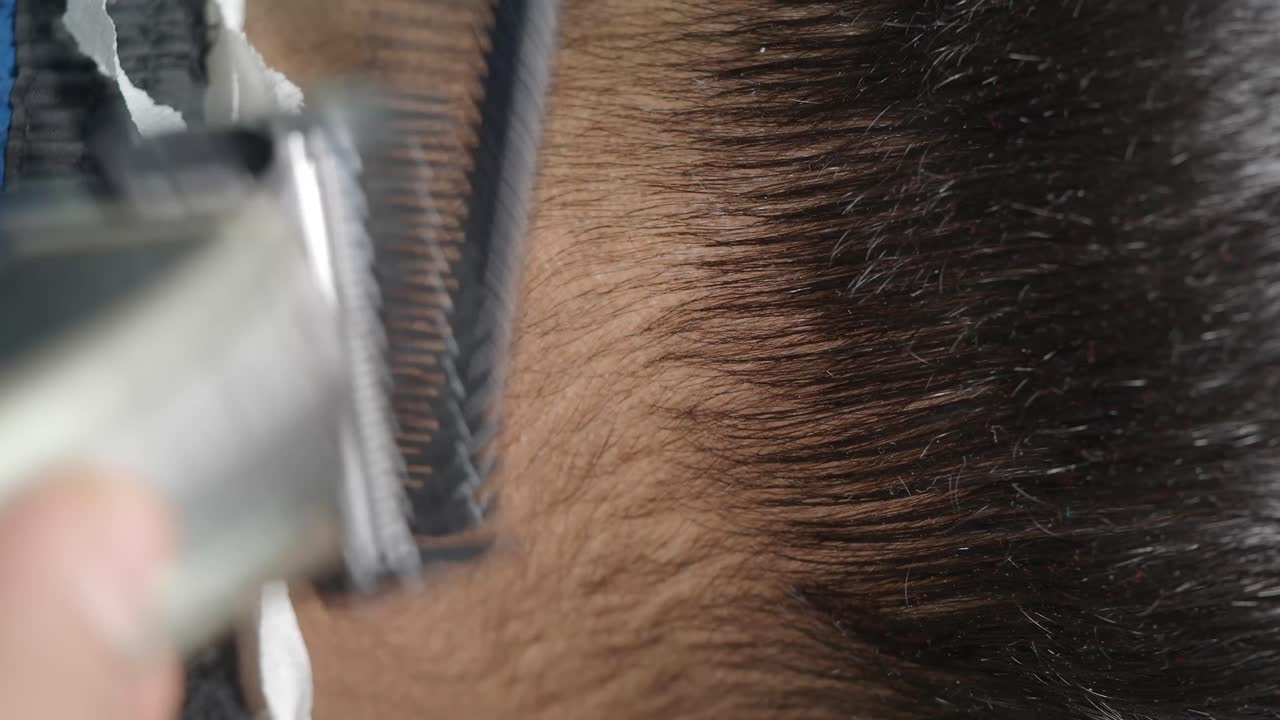 Close-up of a person's dark hair and hairline