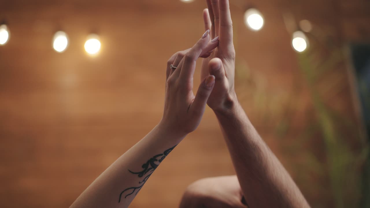 hands of man and woman are flirting with each other with motions in the room on the eve of St. Valentine's Day