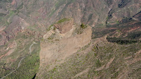 aerial circle view on side of roque nublo, on a bright, sunny day