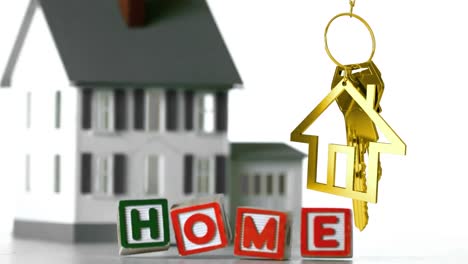 animation of wooden blocks with text home and golden house shape with key over house