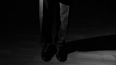 Shiny dress shoes and fancy pants.
