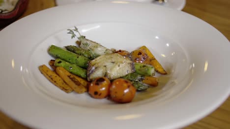 Close-up-delicious-food-on-white-plate-at-restaurant-table