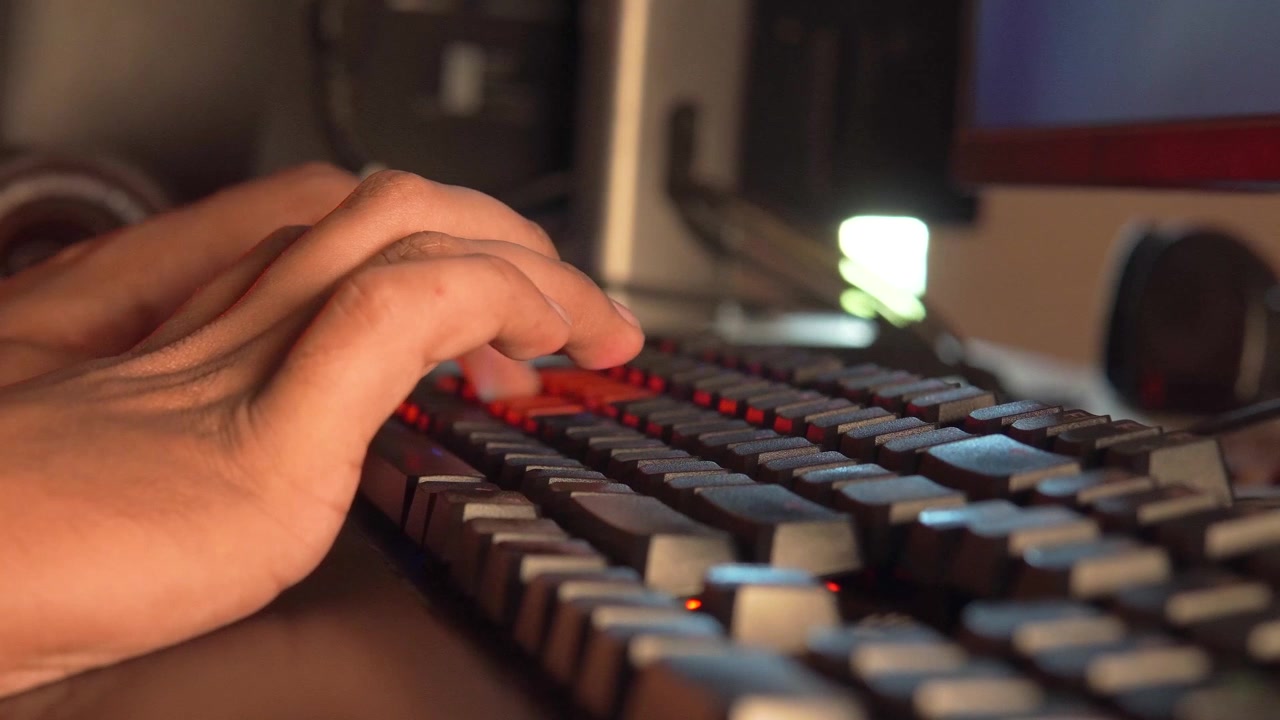 Closeup of a Man Typing on a Keyboard, Hands on the Keyboard, Workspace