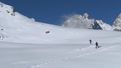 hikers snowshoe skiing in powder snow of the alps of tyrol, winter in austria