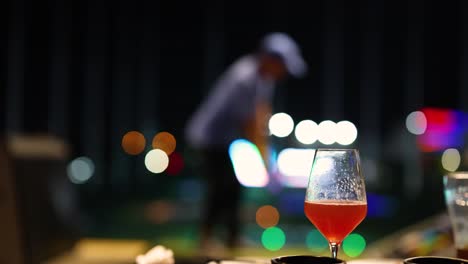 golf practice with a drink in focus