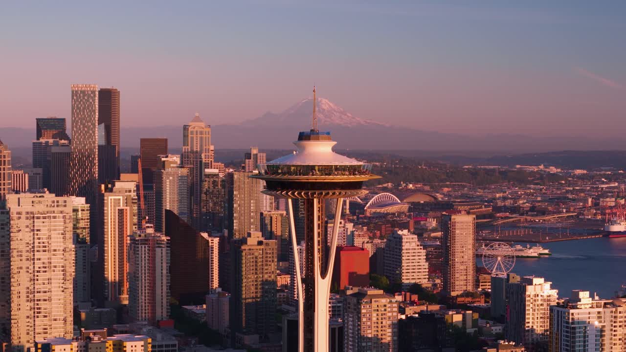 Drone shot approaching the Seattle Space Needle with Mount Rainier off in the distance.