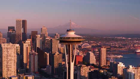 drone shot approaching the seattle space needle with mount rainier off in the distance.