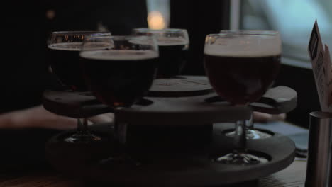 In-cafe-on-table-is-a-rotating-tray-of-drinks-girl-twists-the-tray-and-selects-a-glass